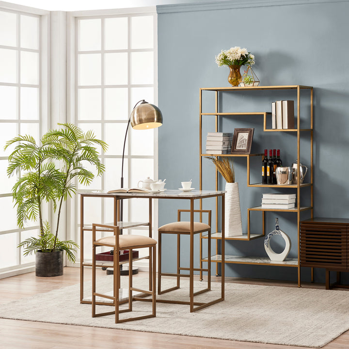 Teamson Home Marmo Modern Breakfast Table Set in Faux Marble/Brass next to a matching faux marble and brass shelf and potted plant