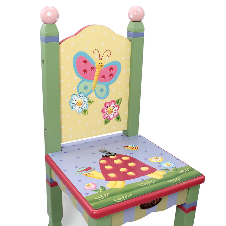 Closeup of the illustrations on a child's chair - butterfly, two flowers, turtle,  worm, bee, and more flowers