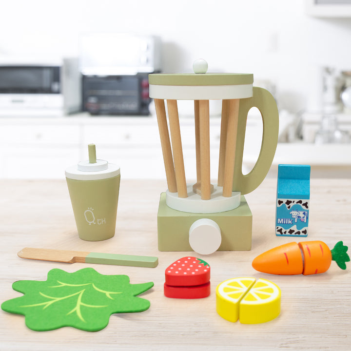 Teamson Kids Little Chef Frankfurt Wooden Blender Play Kitchen Accessories, Green toy set with pretend ingredients on a kitchen countertop.