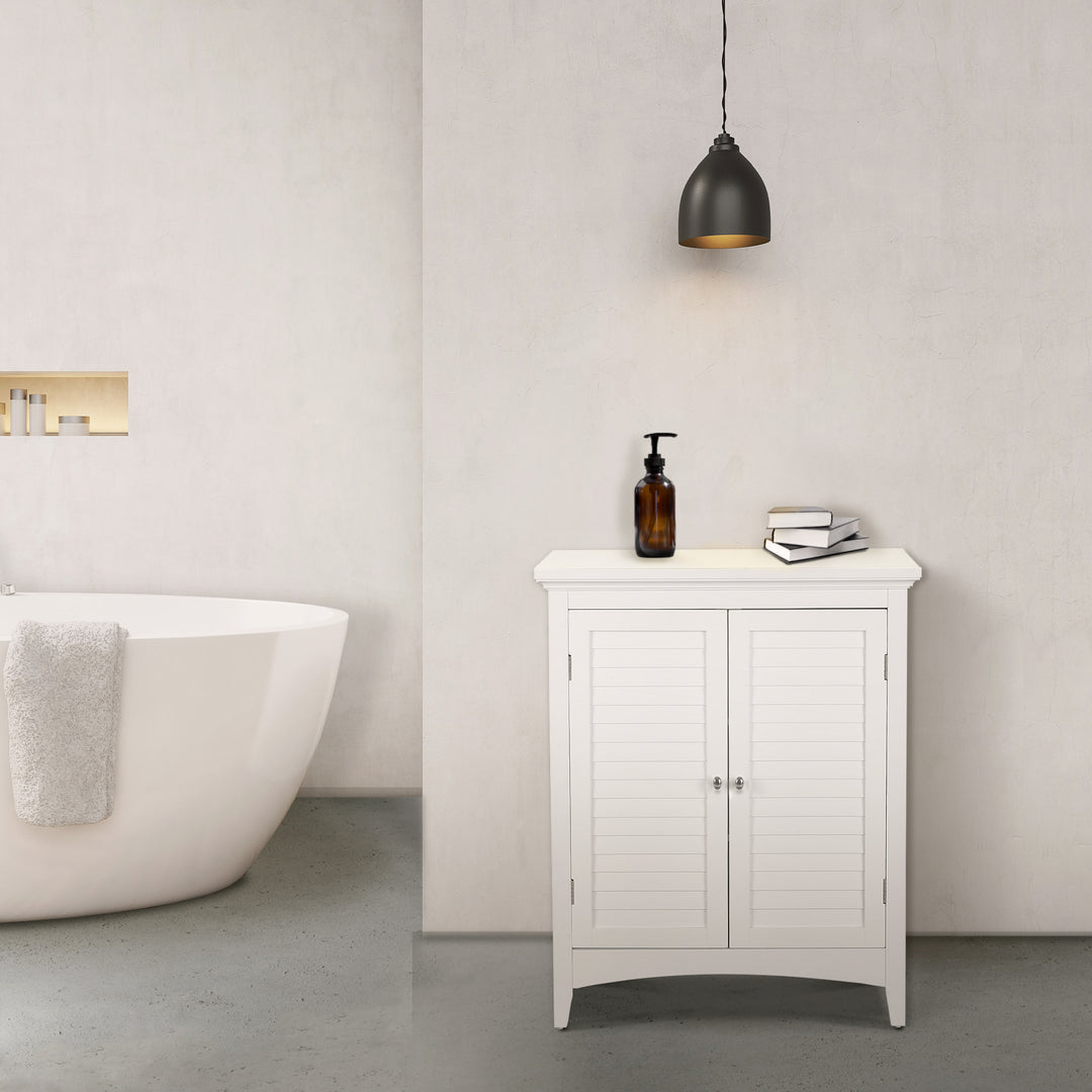 White Glancy 2-Door Floor Cabinet with Louvered Doors, Chrome Knobs in a modern bathroom underneath a hanging pendant light.