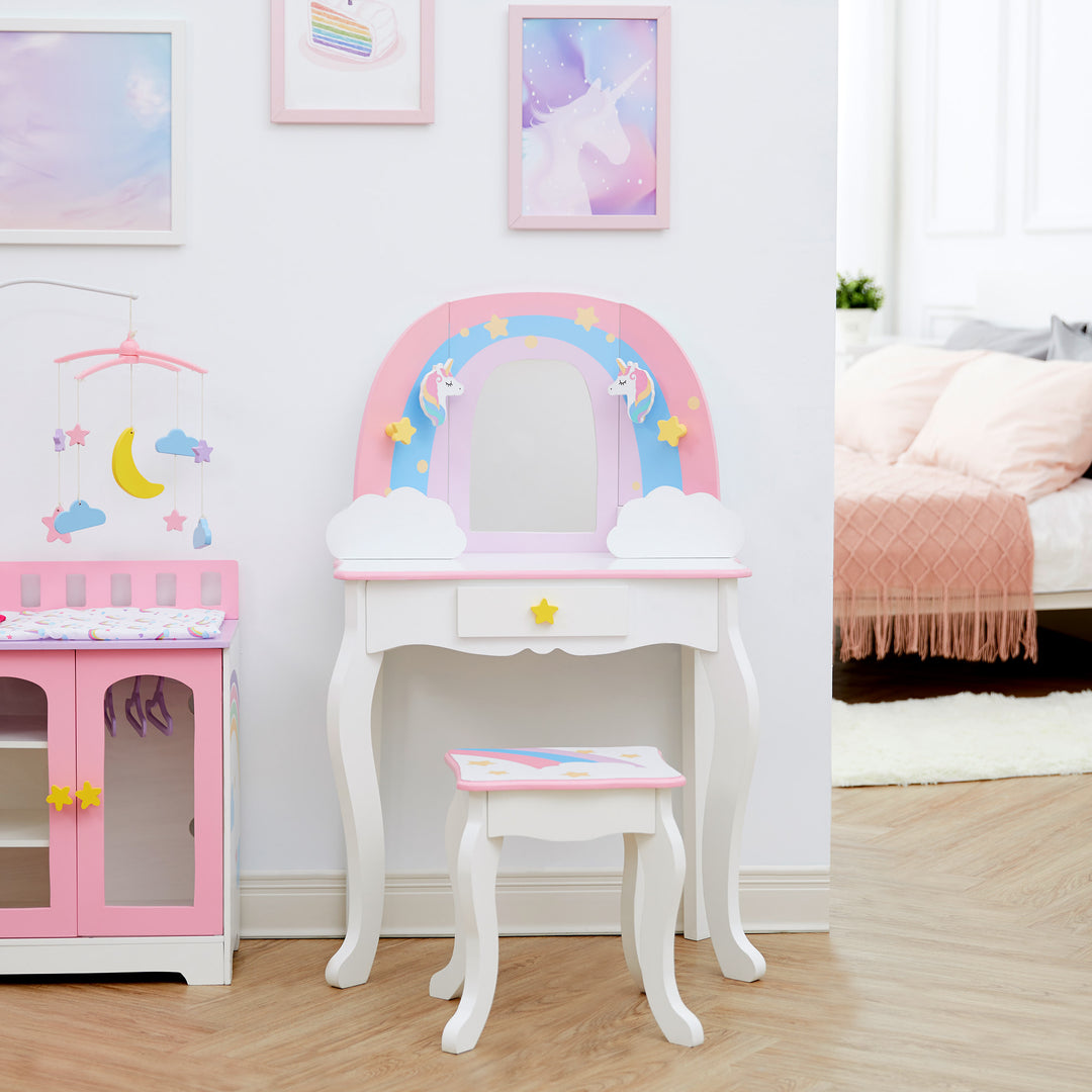 A white vanity table and stool with a rainbow, unicorns, stars, and a mirror in a bedroom.