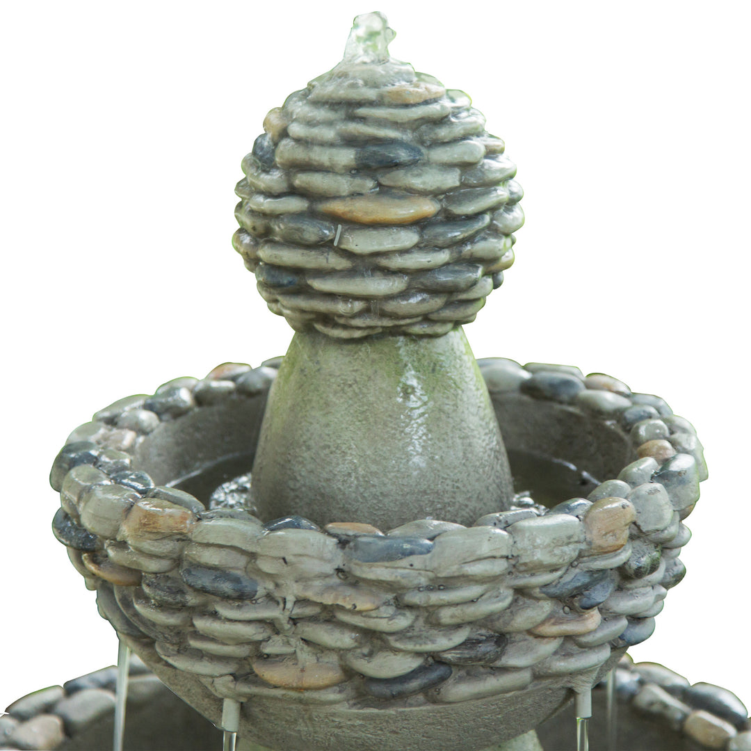 A close-up of where the water bubbles up and down each tier of the faux rock accents on each tier of the water fountain