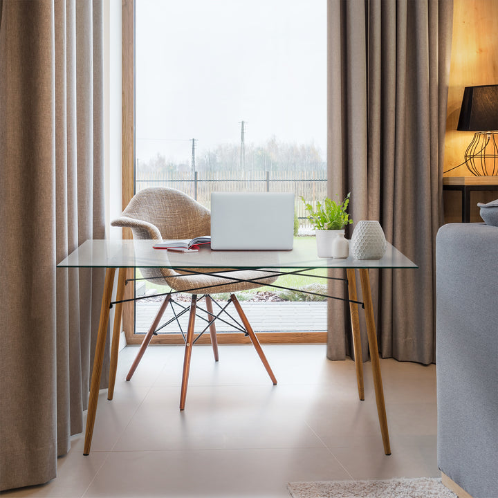 A Teamson Home Minimalist Glass Top Dining Table with Wood Base, Natural with a laptop on it.