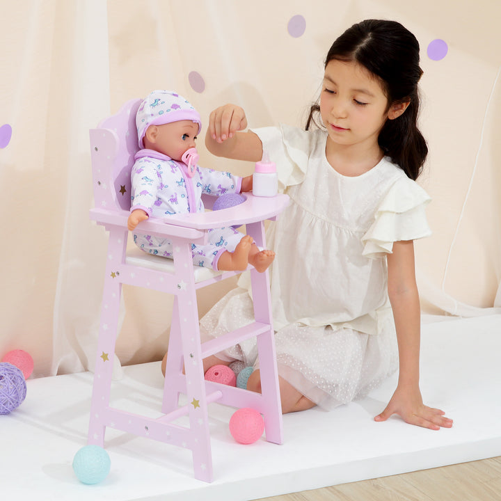 A girl playing with a baby doll sitting in a high chair, purple with white and gold stars.