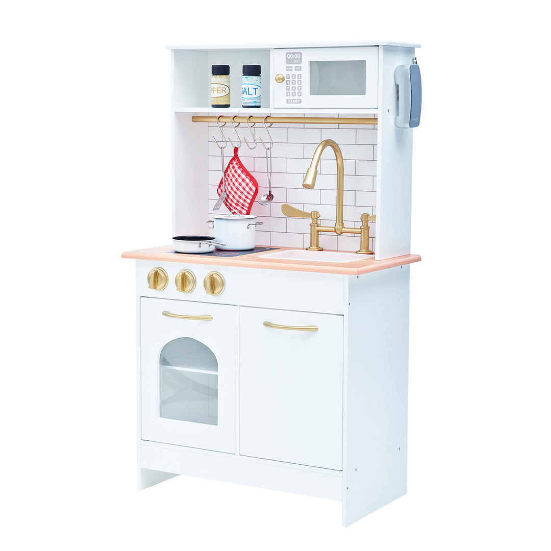 Kids white play kitchen. Small and compact with a sink, microwave, stove and oven. Gold faucet with a brick backsplash.